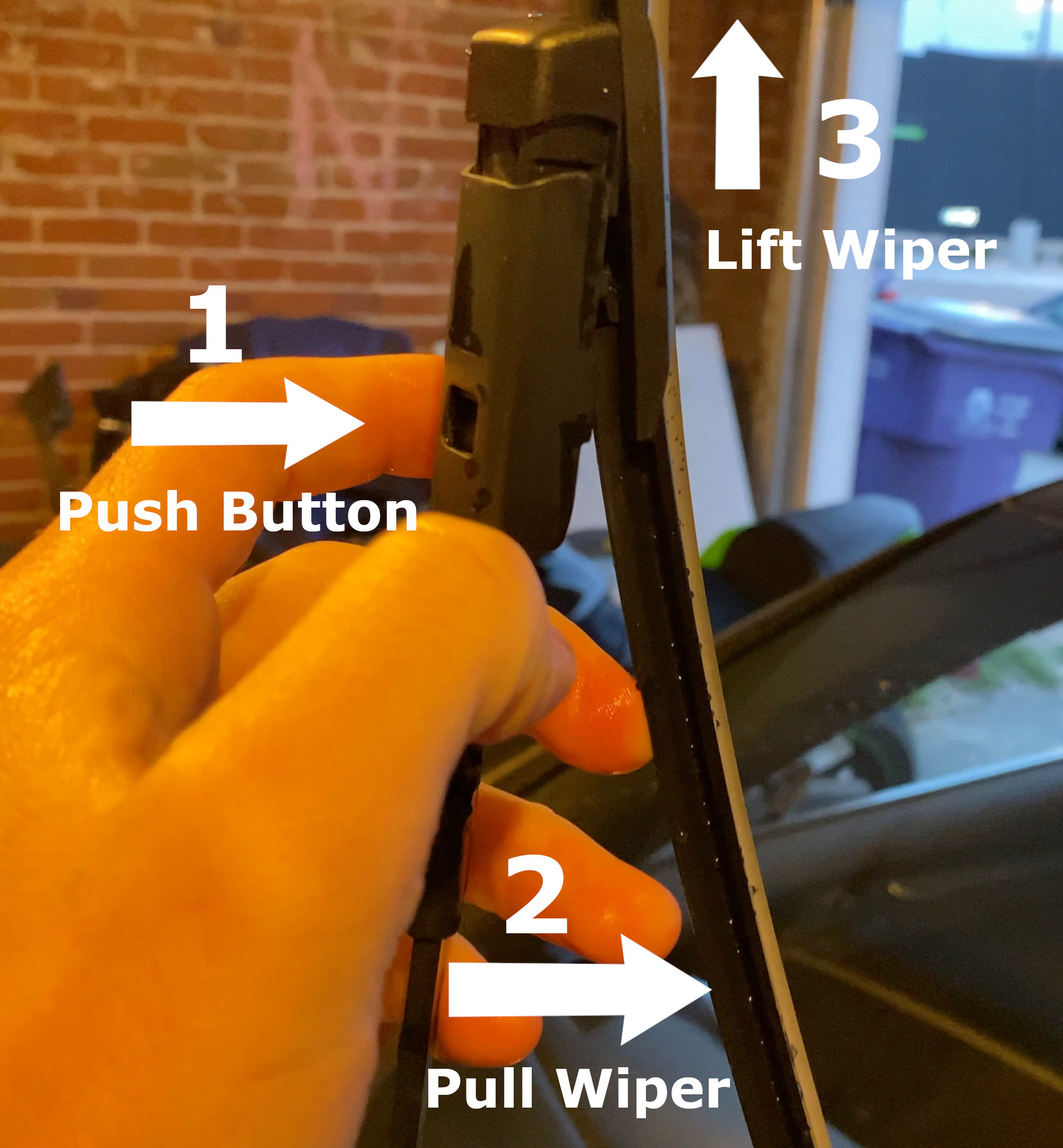 Screenshot of how to remove windshield wipers: push button, pull wiper away from harness, pull wiper out of harness